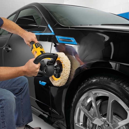 Variable speed polisher with soft start being used to polish car.